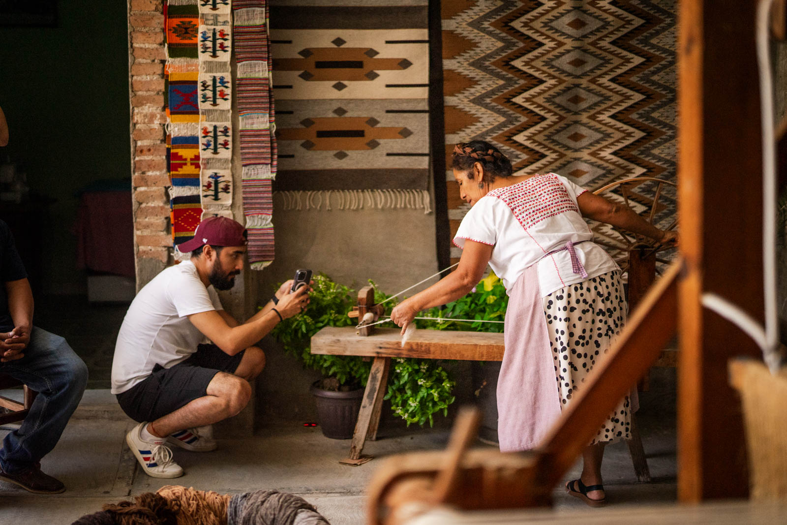 An artisan demonstrates traditional weaving at an Oaxaca Amor Story cultural journey.